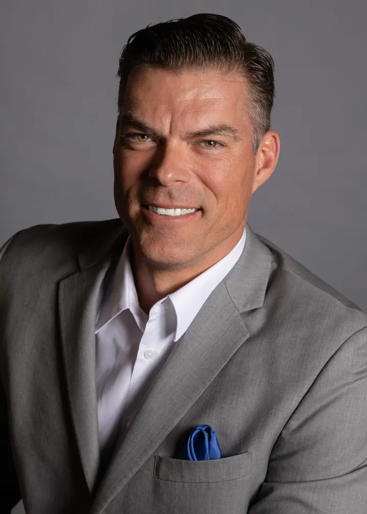 Man in gray suit with blue pocket square