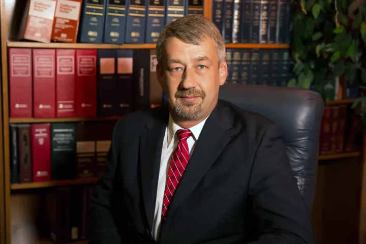 Attorney seated in office with law books