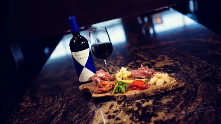 Wine bottle, glass, and charcuterie board