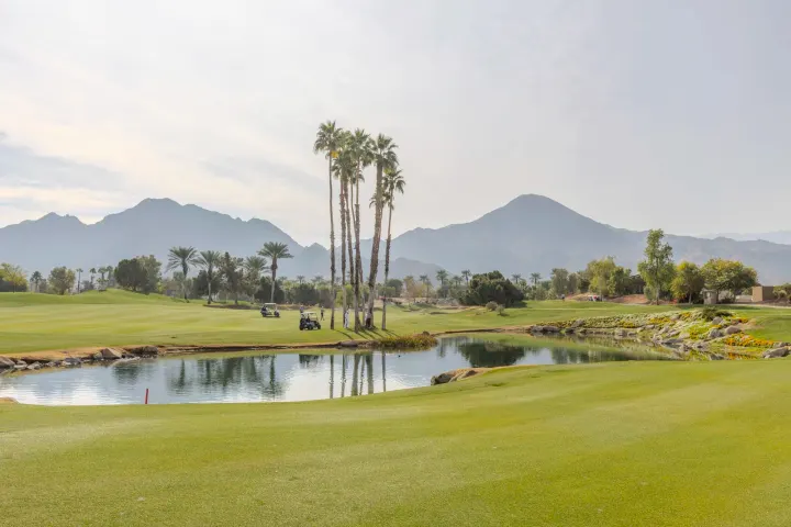 Golf course with palm trees and mountains