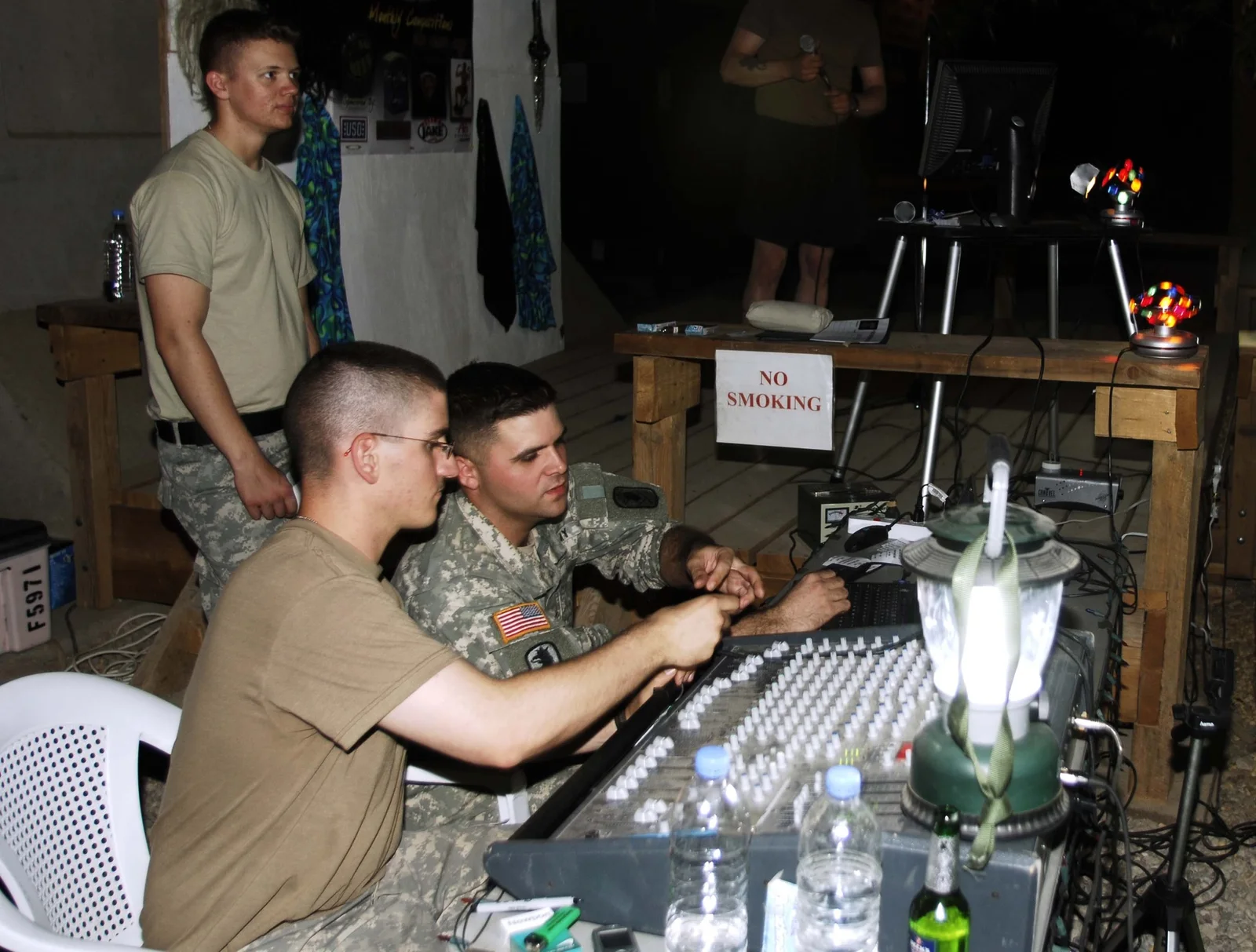 Servicemembers operating karaoke equipment during I-Rock Iraq Karaoke at Camp Victory in Baghdad in 2006